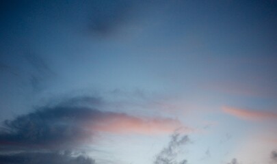 The evening sky, near dusk, had some clouds drifting by, and a soft orange-pink hue contrasted with the deep blue sky © Visuit