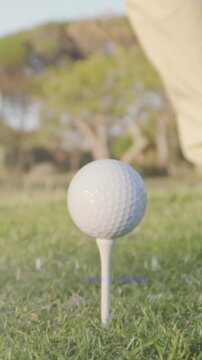 Animation of light trails over senior caucasian man playing golf on golf course