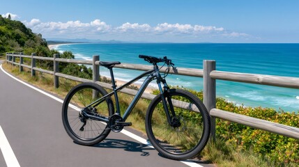 Fototapeta premium Mountain bike standing on coastal path overlooking ocean