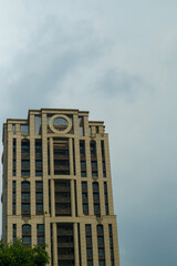 Fototapeta premium Distinctive cylindrical-topped office tower rising against a cloudy sky in Taipei, Taiwan