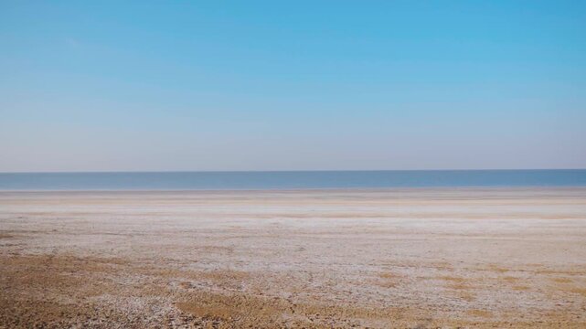 Wide angle shot of Rann of Kutch filled with water during the monsoon season at Kutch in Gujarat, India. Scenic view of White desert of Kutch after the rain. Scenic natural background with copy space.