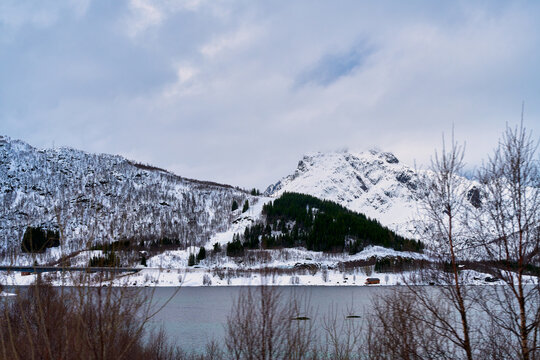 Scenic winter landscape of fjord and snow covered mountains in Lofoten Norway