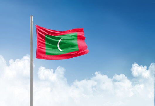Maldives flag waving in beautiful sky.