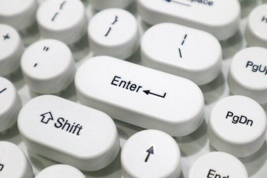 a white typewriter style mechanical keyboard with Enter and Shift keys