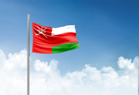 Oman flag waving in beautiful sky.