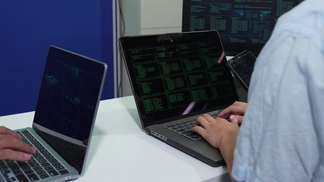 Male coder or developer working overtime using a computer display in problem solving at workplace.