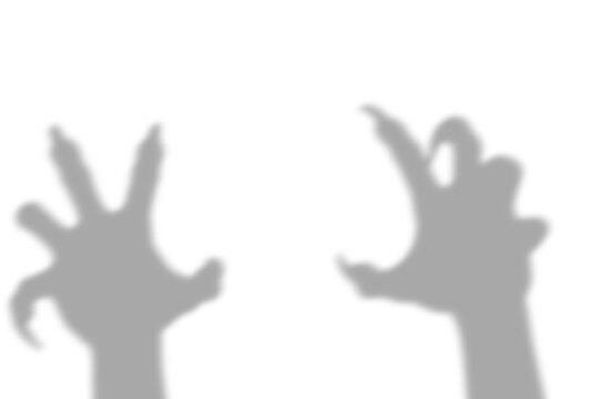 A dark scary shadow of a monster hand with long sharp claws reaching out in a threatening gesture isolated on transparent background