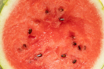 A close-up of juicy watermelon flesh with seeds, related to fresh fruit, summer food, dessert © Виктория Котлярчук