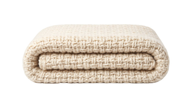 Chunky knit wool blanket in cream white. Folded soft textile throw for home decor. Cozy woven cotton blanket on white background.