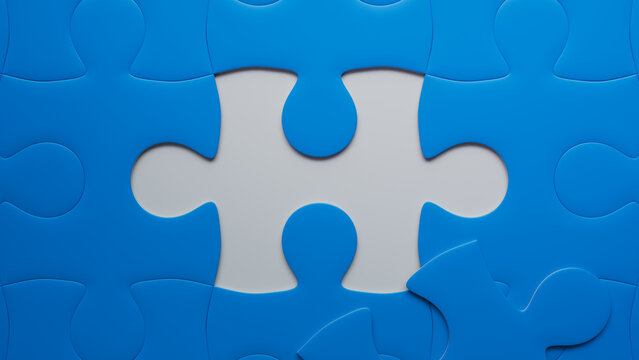 Blue and White Jigsaw Puzzle Backdrop focusing on the last piece to go into place. Missing Piece Concept.