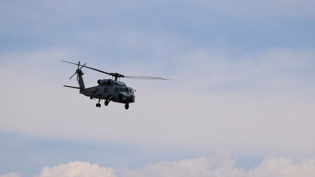 Military MH-60R Seahawk Helicopter Flying Against a Cloudy Sky