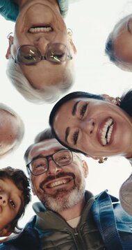 Below, face and family in nature with smile, love and bonding together on holiday reunion. Portrait, parents and grandparents outdoor with child, people and generations gathering on vacation getaway