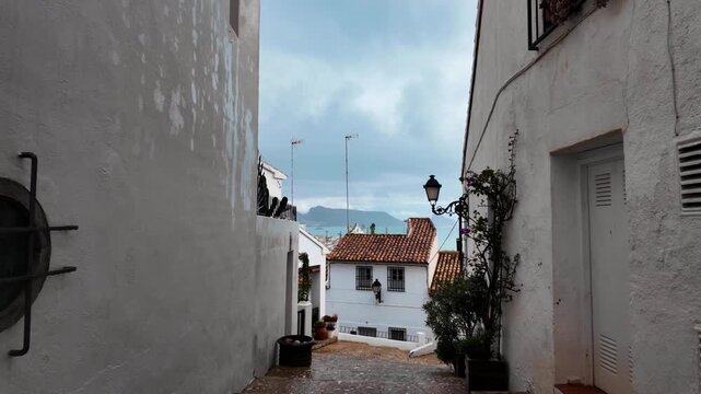 Old town narrow street view of Mediterranean sea, Altea, Spain