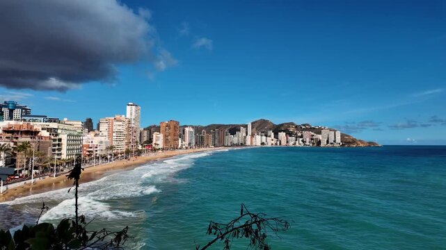 Coastal pan across Levante Beach and Mediterranean Sea, Benidorm, Spain