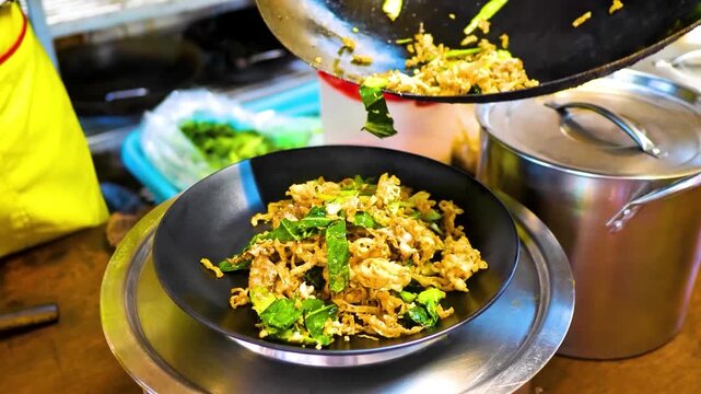 A close-up food scene featuring stir-fried noodles topped with fresh herbs and vegetables, ideal for culinary and restaurant concepts 4k