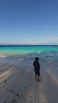 Person Standing on Tropical Beach at Sunny Day
