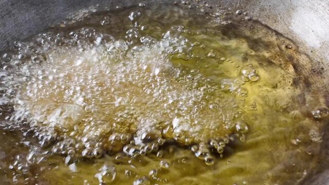 cooking chicken in the deep frying method.