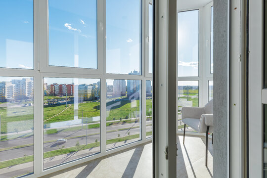 Modern Balcony Interior with Panoramic Windows and Armchair