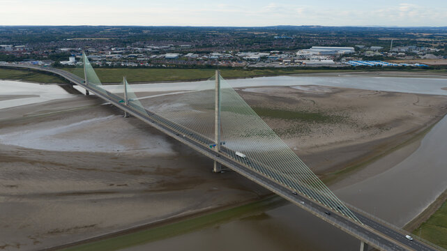 Aerial view of the Mersey Gateway Bridge spanning the River Mersey with traffic flowing across the cable-stayed structure in Runcorn, United Kingdom.
