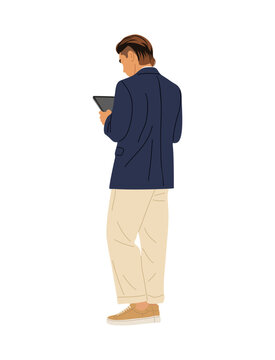 Man stands, back turned, holding tablet. Dressed in navy blazer and beige trousers. Neutral stance suggests focus or thoughtfulness. Ideal for business, tech, or modern professional scenes