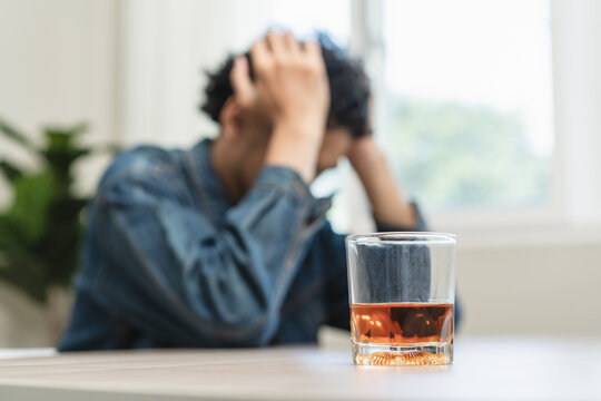 depression and anxiety woman drinking whisky alone.