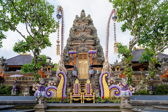 BALI, INDONESIA &ndash; OCTOBER 20, 2024: Elaborate Kori Agung gate decorated with ceremonial penjor and purple fabrics at Pura Taman Saraswati temple in Ubud.