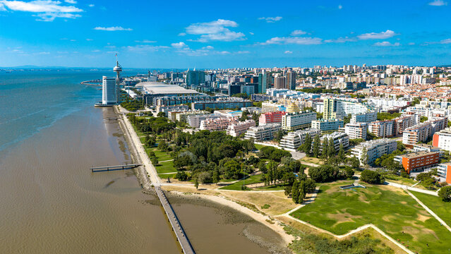 Aerial view of the Parque das Nacoes waterfront in Lisbon, featuring the Vasco da Gama Tower, modern architecture, green parks, and the Tagus River. Lisbon, Lisbon, Portugal.