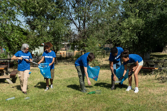 Community volunteers cleaning up litter and plastic waste in a park