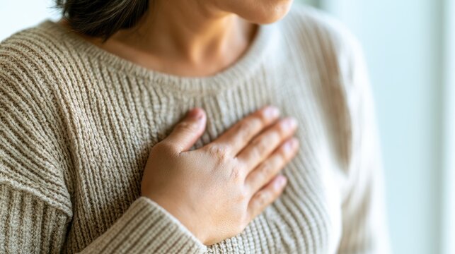 hand hold chest with heart attack symptoms, have chest pain caused by heart disease, leak, dilatation, enlarged coronary heart, press on the chest with a painful expression