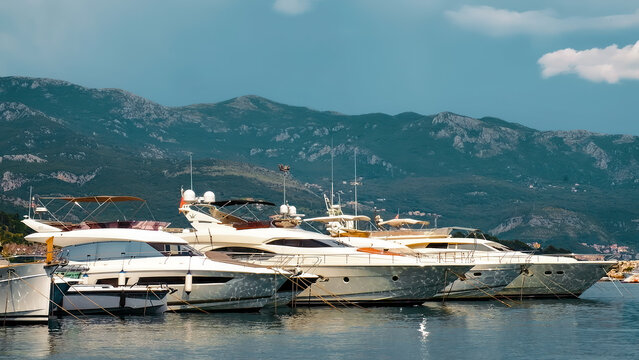 Yacht near coastline of Budva in summer season. European town on Adriatic sea