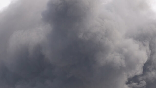 Thick Dark Billowing Smoke Clouds From an Explosion at an Airshow