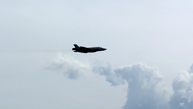 Military Stealth Fighter Jet Flying Through Cloudy Sky at Avalon Airshow
