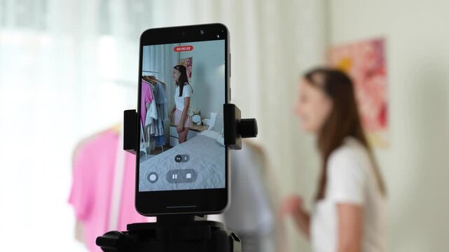 Teenage girl creating a fashion vlog, presenting clothes and outfits on camera, social media content and youth lifestyle