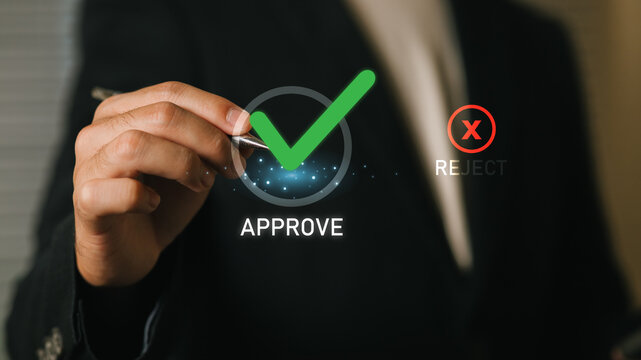 A professional individual in a business suit interacts with a digital approval icon, symbolizing decision-making and technological advancement in modern business environments.