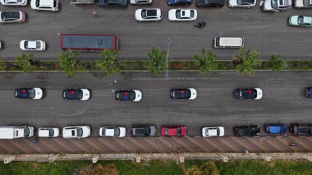 Aerial drone view of tourism police vehicles and officers in Aleppo, Syria. Syrian tourism police convoy driving through city streets after the fall of Bashar al-Assad. New Syrian government security 