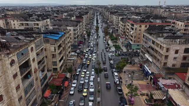 Aerial drone view of tourism police vehicles and officers in Aleppo, Syria. Syrian tourism police convoy driving through city streets after the fall of Bashar al-Assad. New Syrian government security 