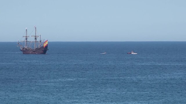 Historic Galleon with Spanish flag sailing close to the coast of Ireland in County Donegal