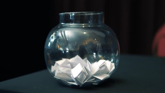 Traditional Indian Game Parchi Paper Slips Folded and Stored Inside a Glass Jar