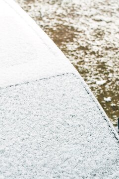 Frozen car windshield after cold night snowfall
