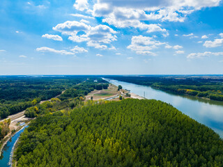 Fototapeta premium Beautiful river winding through green landscape under blue sky with clouds in daytime