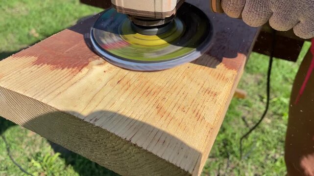 Close-up video of grinding a wooden plank with an angle grinder. 