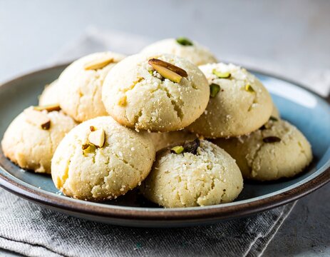 Traditional Homemade Nankhatai Shortbread Cookies with Pistachio and Almond on Ceramic Plate
