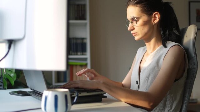 Young businesswoman working on a laptop in a home office