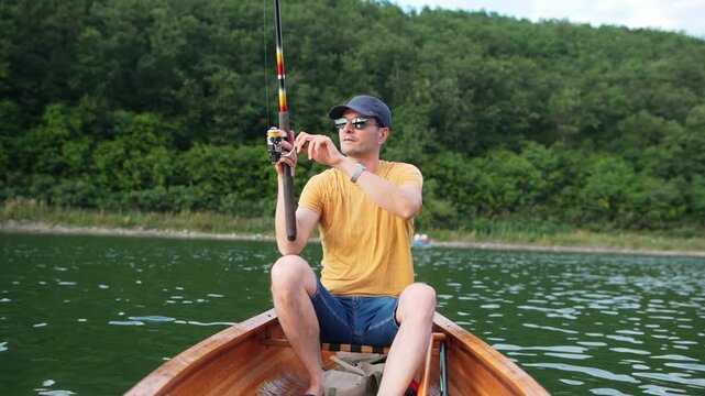 Man fishing from wooden canoe
