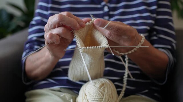 Senior woman knitting close up