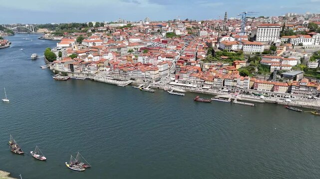 Porto city life and tourism concept aerial drone view of the Douro river with Arr&aacute;bida Bridge traditional boats and historic architecture in Portugal old town
