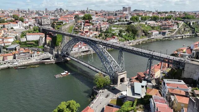 Porto city skyline and Dom Lu&iacute;s i bridge over the Douro river Portugal aerial drone shot of urban architecture and infrastructure cityscape