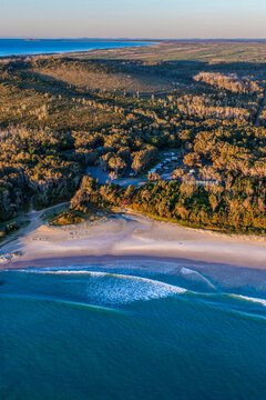 Aerial view of Diamond Head Campground beside the sandy beach and Pacific Ocean, surrounded by native coastal vegetation and natural landscape in Crowdy Bay National Park on the Mid North Coast 