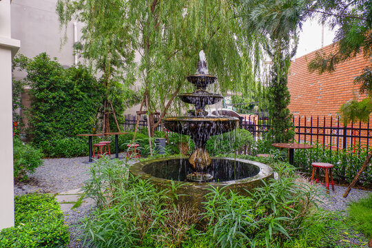 Luxury Fountain at green garden in house outdoor garden,Scenic View of a Beautiful English Style Landscape Garden in summer,selective focus.
