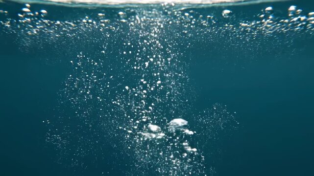 Underwater Air Bubbles Rising Through Deep Blue Water, Ideal for Aquatic Backgrounds.